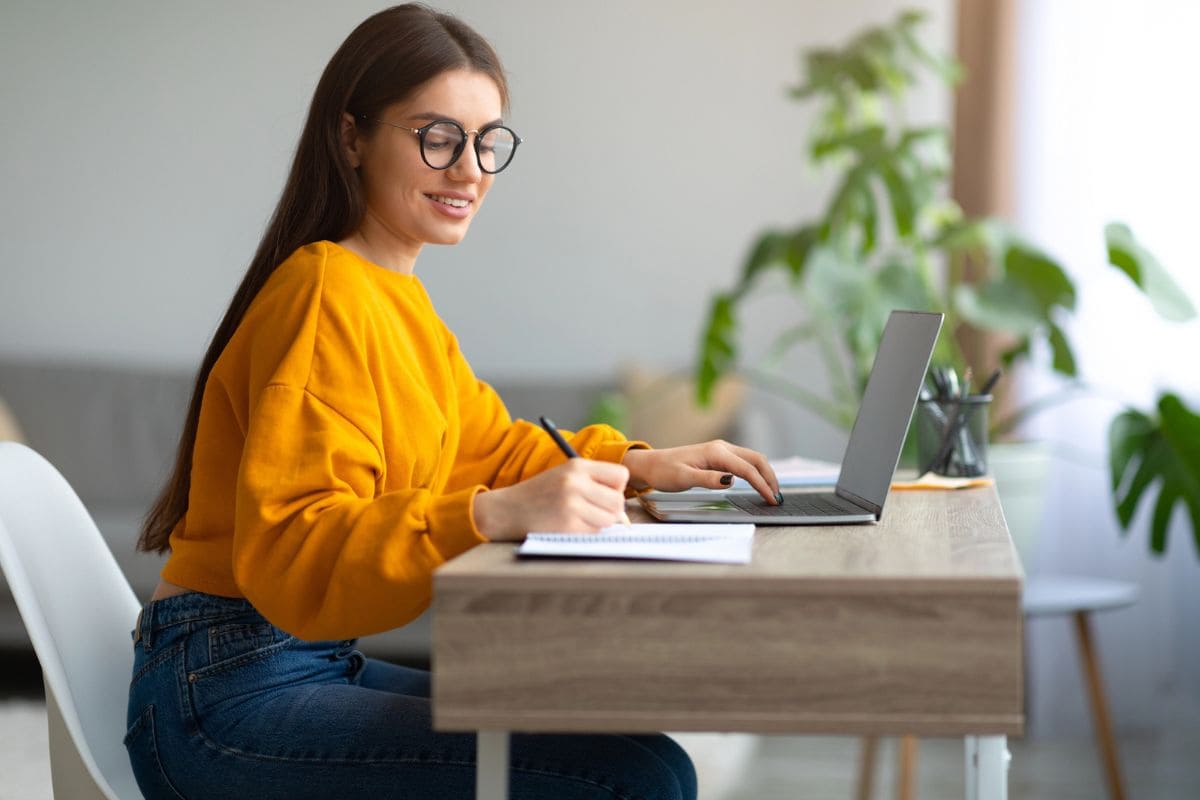 A woman wearing glasses looking for good remote jobs for people with ADHD.