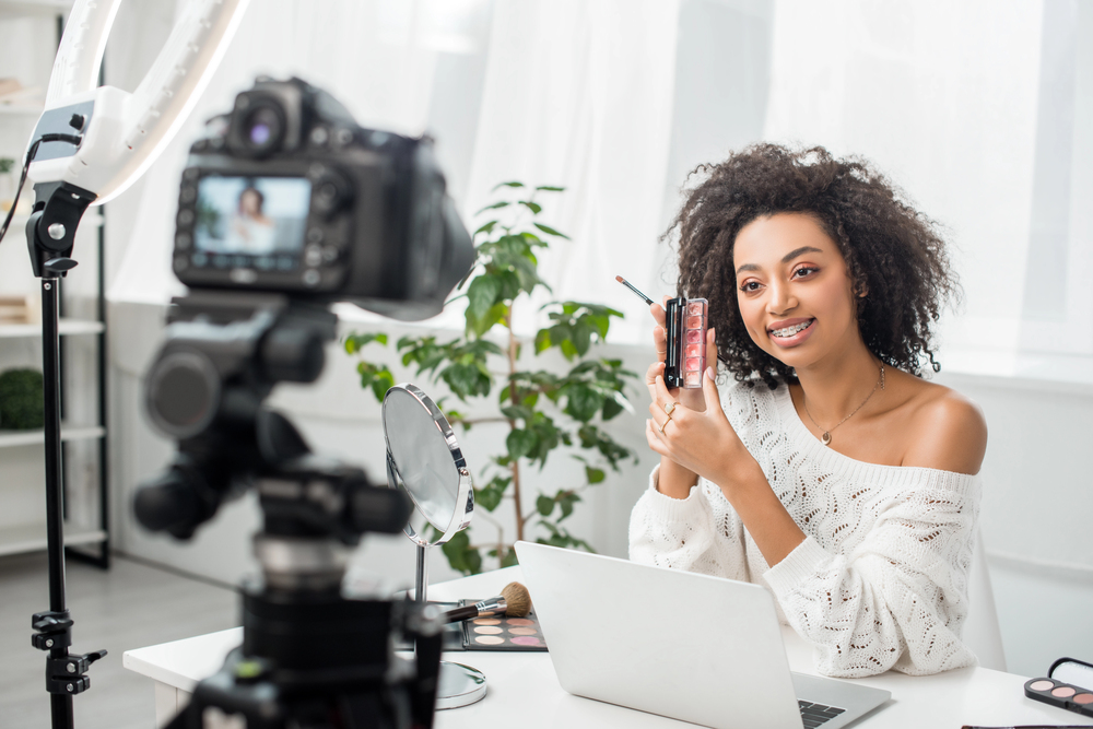 A beauty influencer filming a video for her lip gloss business