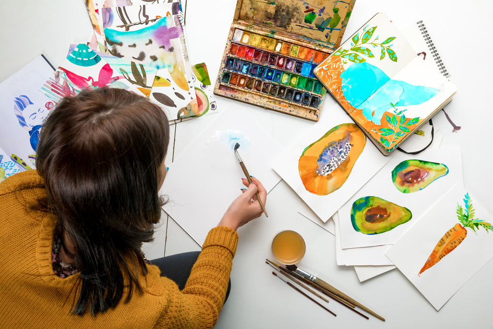 A woman painting to sell art online