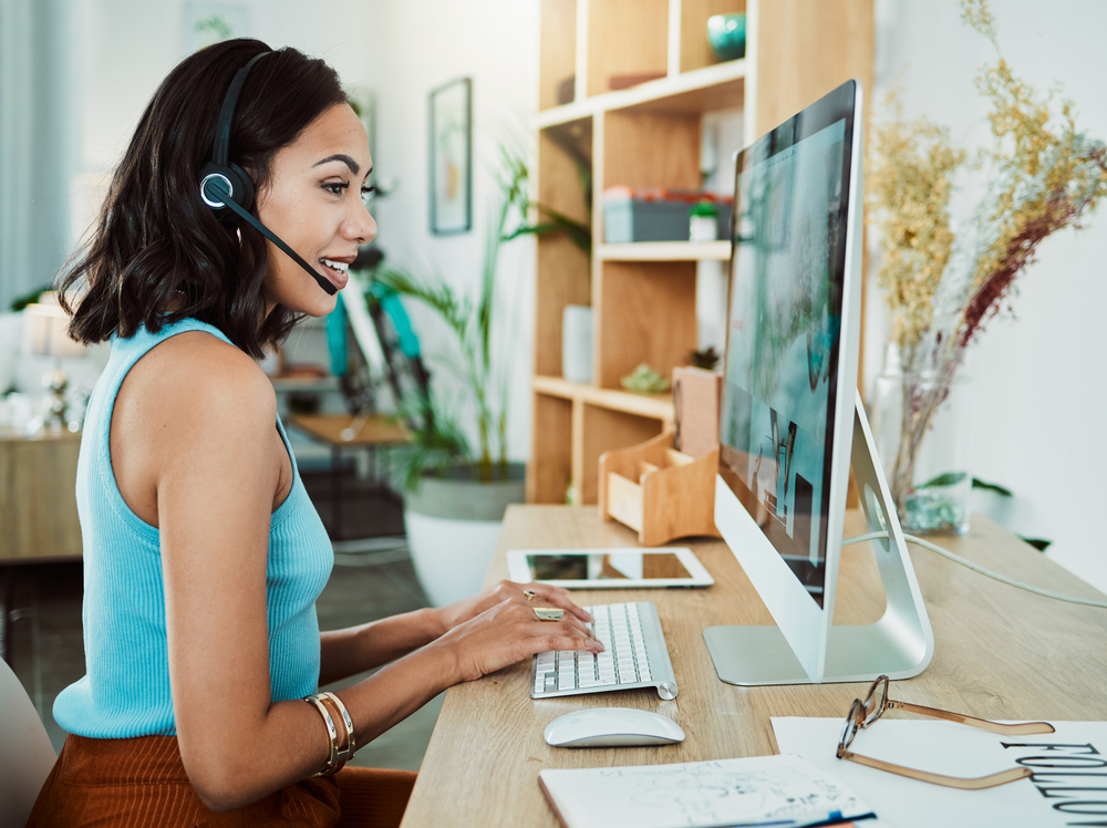 A young stylish woman working her remote customer service job