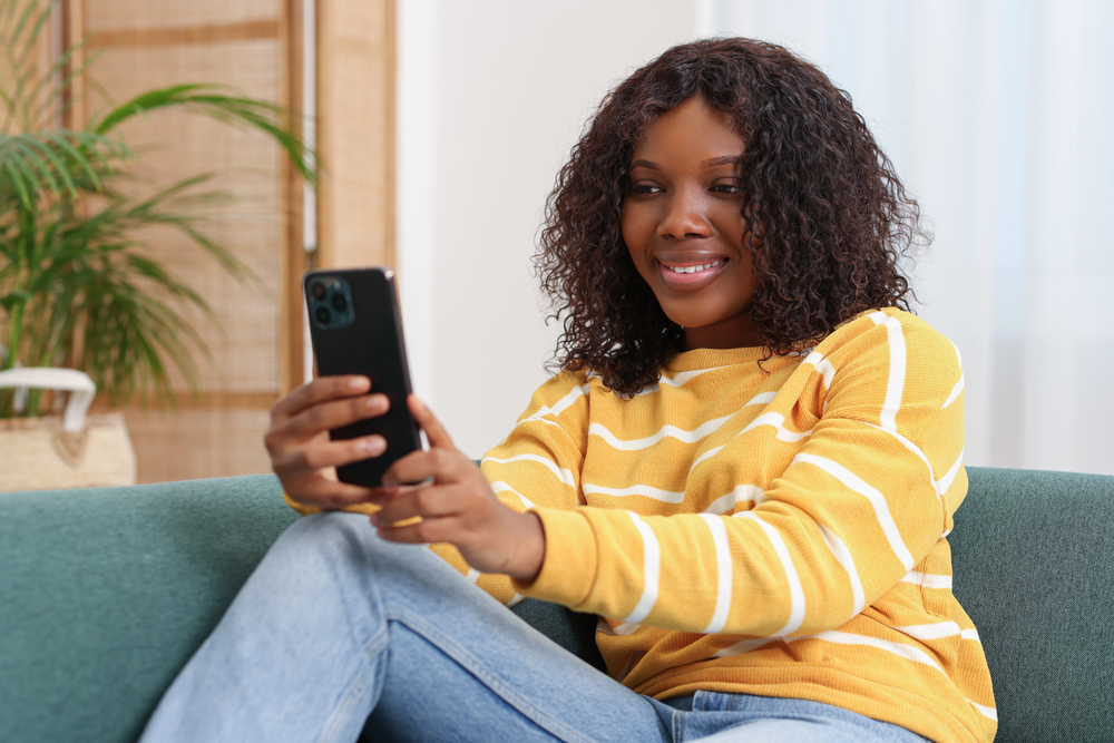 A young woman taking a video survey on her smartphone with Mindswarms