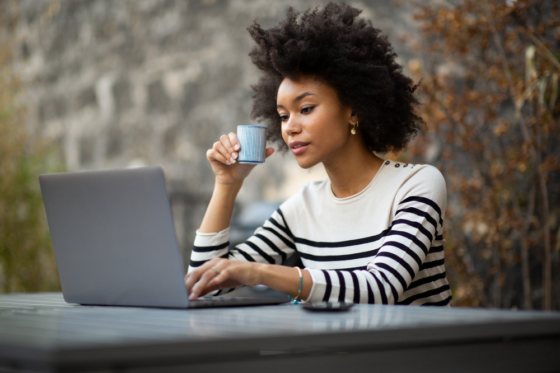 Woman taking surveys with User Interviews on her laptop