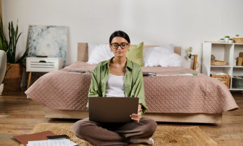 Woman wearing glasses working on her laptop trying to make $2,000 a month working from home