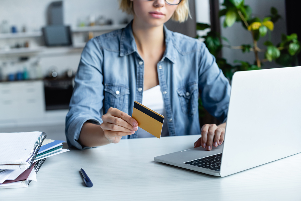 Young woman reading how to earn free Amazon gift cards online